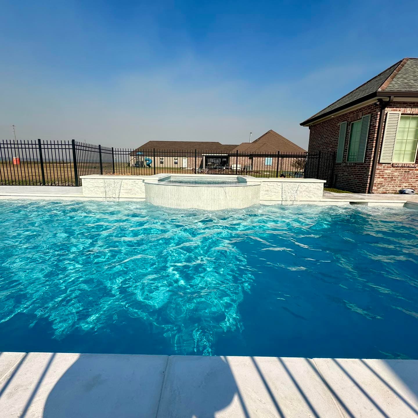 Spillover spa next to pool in Thibodaux